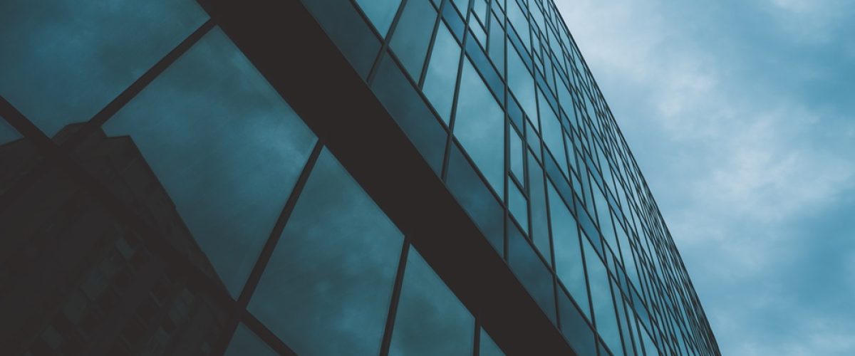 Low-angle,Perspective,Of,A,Contemporary,High-rise,Office,Building,With,Reflective
